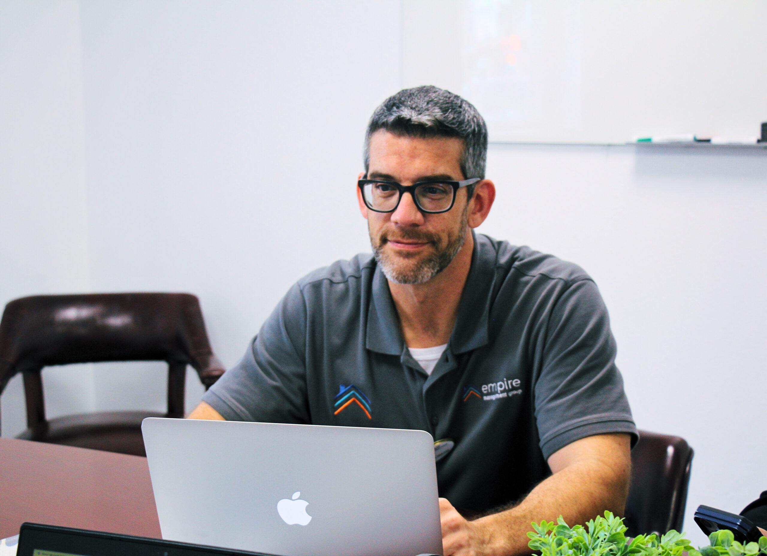 middle aged businessman working on laptop in office